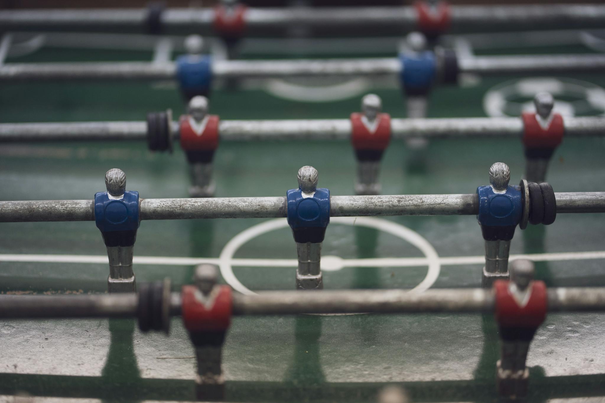 Detailed image of foosball game players on a field. Great for sports or recreational themes.